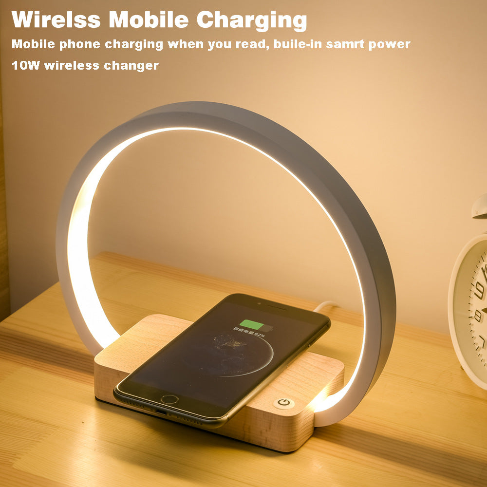Wireless charging device with a phone on a wooden base, glowing softly.