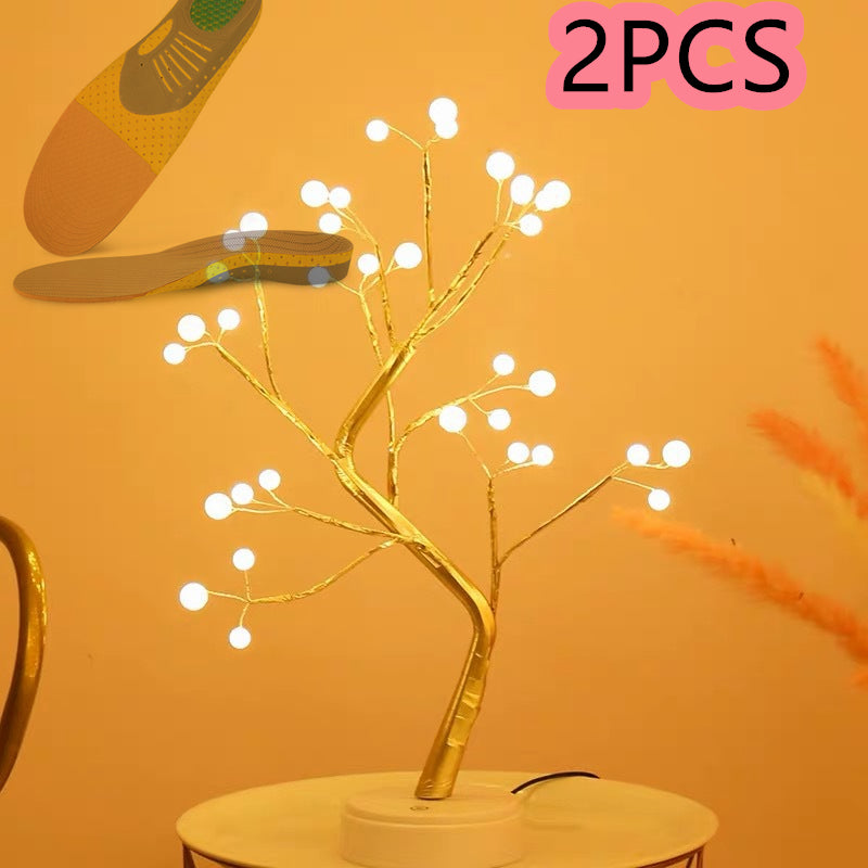 Decorative LED branch light on a stand with '2PCS' text above on an orange background