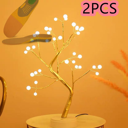 Decorative LED branch light on a stand with '2PCS' text above on an orange background