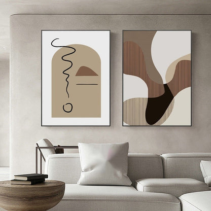 Two abstract art pieces on a wall above a sofa in a living room.